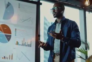 Professional presenting security data charts and graphs on a display board in a modern office setting.